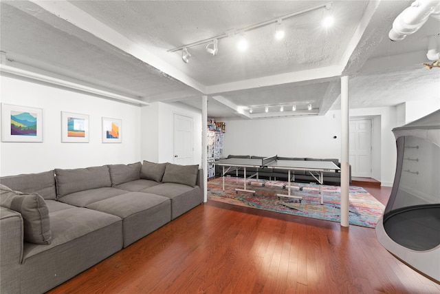 living area featuring rail lighting and wood finished floors