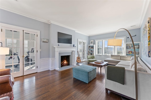 27 Calumet Ave, Hastings-On-Hudson, NY 10706 - living area featuring dark wood-style floors, a warm lit fireplace, crown molding, and french doors
