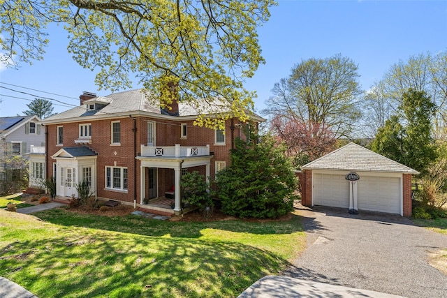27 Calumet Ave, Hastings-On-Hudson, NY 10706 - view of front of property featuring a balcony, an outdoor structure, brick siding, a garage, and a front lawn