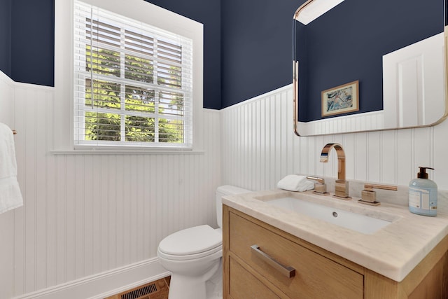 5 Briarcliff Rd, Chappaqua, NY 10514 - half bathroom with vanity, toilet, and a wainscoted wall