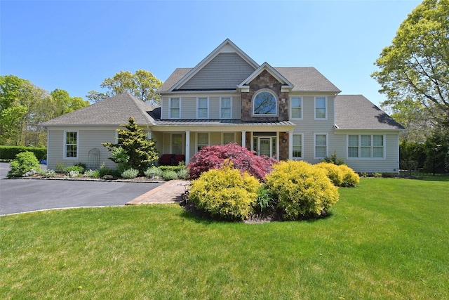 103 Silver Beech Ln, Calverton, NY 11933 - view of front facade featuring stone siding, a front lawn, and roof with shingles