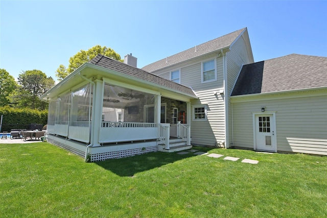103 Silver Beech Ln, Calverton, NY 11933 - rear view of house featuring a chimney, a shingled roof, a sunroom, a patio, and a yard