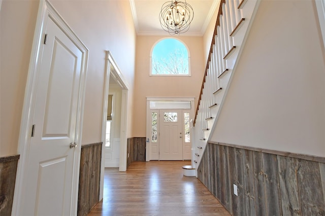 103 Silver Beech Ln, Calverton, NY 11933 - foyer entrance featuring stairs, a notable chandelier, wood finished floors, wainscoting, and ornamental molding