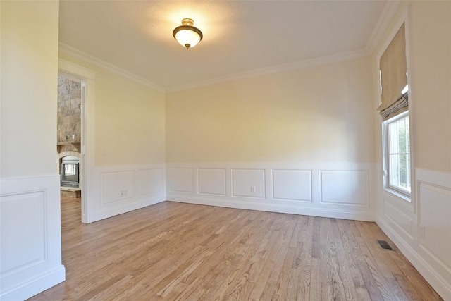 103 Silver Beech Ln, Calverton, NY 11933 - empty room with a wainscoted wall, visible vents, wood finished floors, and ornamental molding