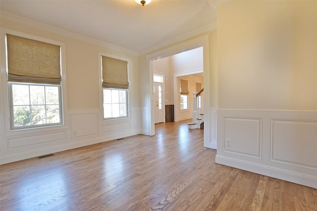 103 Silver Beech Ln, Calverton, NY 11933 - empty room featuring stairs, visible vents, light wood-style flooring, and ornamental molding