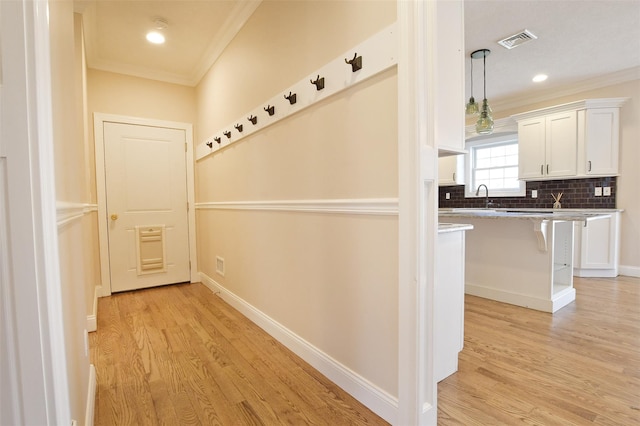 103 Silver Beech Ln, Calverton, NY 11933 - corridor with baseboards, visible vents, crown molding, and light wood-type flooring