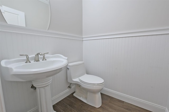 103 Silver Beech Ln, Calverton, NY 11933 - bathroom featuring toilet, a wainscoted wall, and wood finished floors