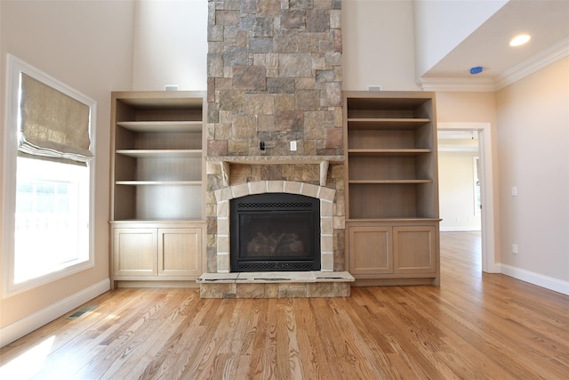 103 Silver Beech Ln, Calverton, NY 11933 - unfurnished living room with baseboards, light wood-type flooring, crown molding, and a fireplace