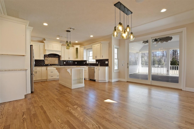 103 Silver Beech Ln, Calverton, NY 11933 - kitchen featuring a kitchen breakfast bar, tasteful backsplash, stainless steel appliances, a center island, and light wood-style floors
