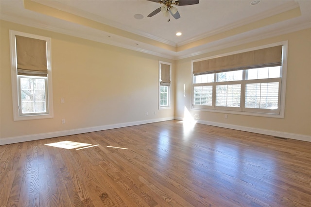 103 Silver Beech Ln, Calverton, NY 11933 - spare room featuring crown molding, a ceiling fan, a raised ceiling, wood finished floors, and baseboards