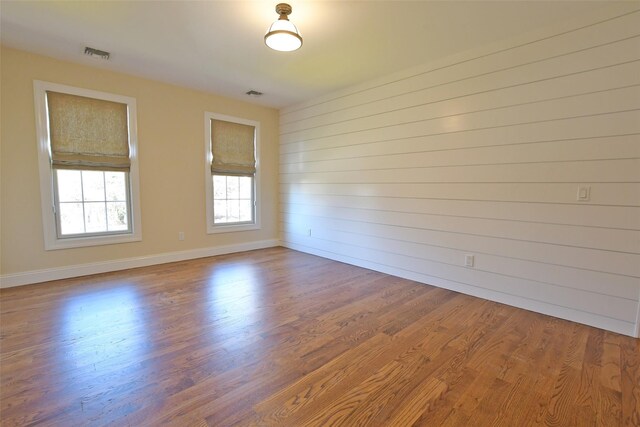 103 Silver Beech Ln, Calverton, NY 11933 - unfurnished room with wood finished floors, baseboards, and visible vents