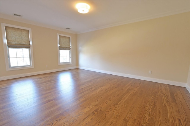 103 Silver Beech Ln, Calverton, NY 11933 - spare room with baseboards, visible vents, crown molding, and wood finished floors