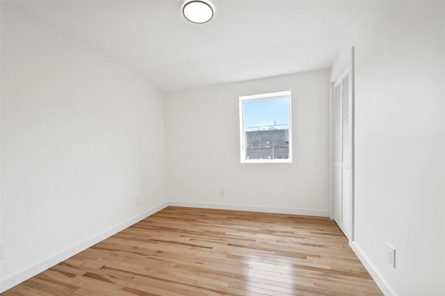 unfurnished room featuring light wood-type flooring and baseboards