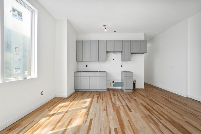 interior space with light wood finished floors and baseboards
