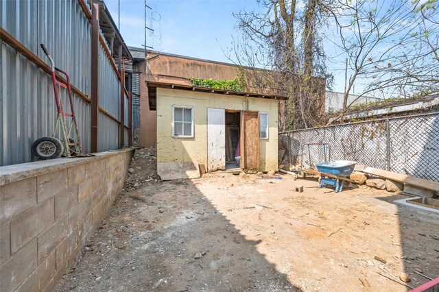 exterior space featuring stucco siding and fence