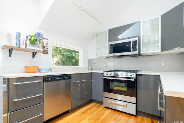 2955 Hyatt Rd, Southold, NY 11971 - kitchen featuring appliances with stainless steel finishes, lofted ceiling, gray cabinets, rail lighting, and light countertops