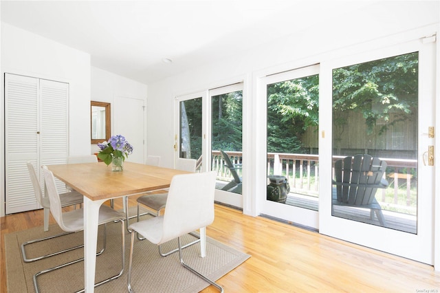 2955 Hyatt Rd, Southold, NY 11971 - dining room featuring wood finished floors and vaulted ceiling