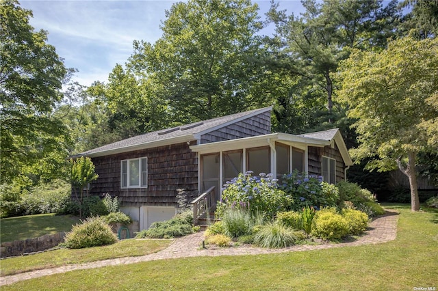 2955 Hyatt Rd, Southold, NY 11971 - view of property exterior with a garage, a yard, a sunroom, and a shingled roof