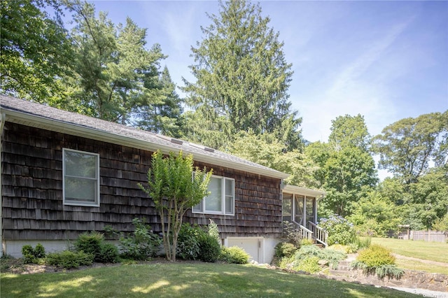 2955 Hyatt Rd, Southold, NY 11971 - view of side of home with a garage, a yard, and a sunroom