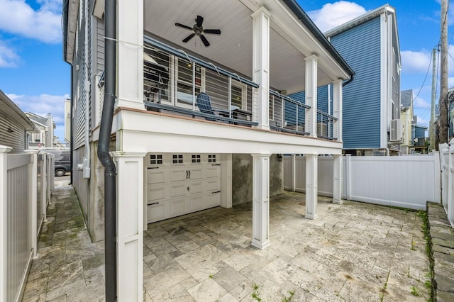 93 Nebraska St, Long Beach, NY 11561 - view of patio featuring a ceiling fan, a balcony, fence, and an attached garage