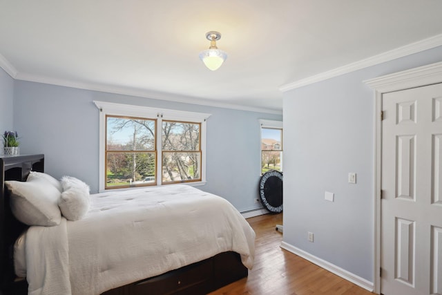 230 W Islip Rd, West Islip, NY 11795 - bedroom featuring wood finished floors, a baseboard heating unit, crown molding, and baseboards