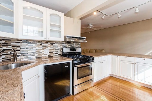 kitchen with dishwasher, ceiling fan, stainless steel range with gas cooktop, under cabinet range hood, and a sink