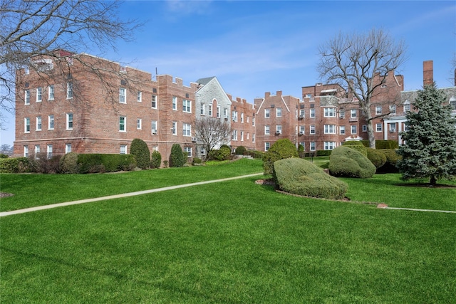 view of home's community featuring a lawn