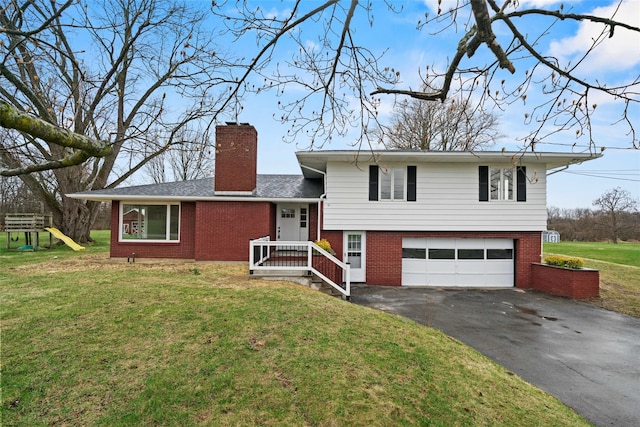 139 Cross Rd, Goshen, NY 10924 - split level home with aphalt driveway, a front yard, brick siding, a chimney, and a garage