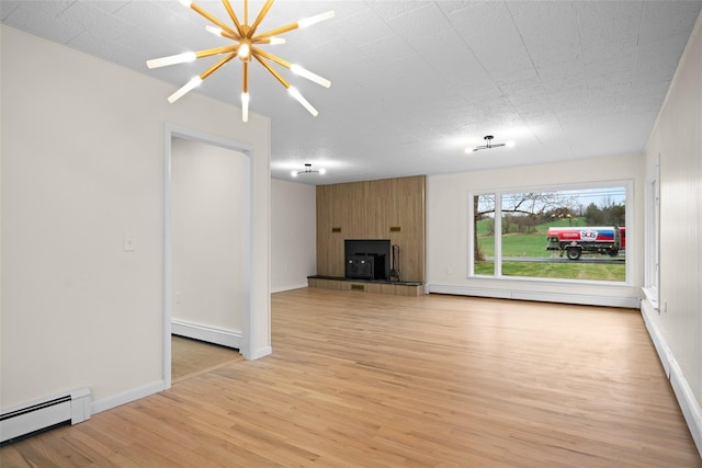 139 Cross Rd, Goshen, NY 10924 - unfurnished living room featuring baseboards, light wood finished floors, an inviting chandelier, and a baseboard heating unit