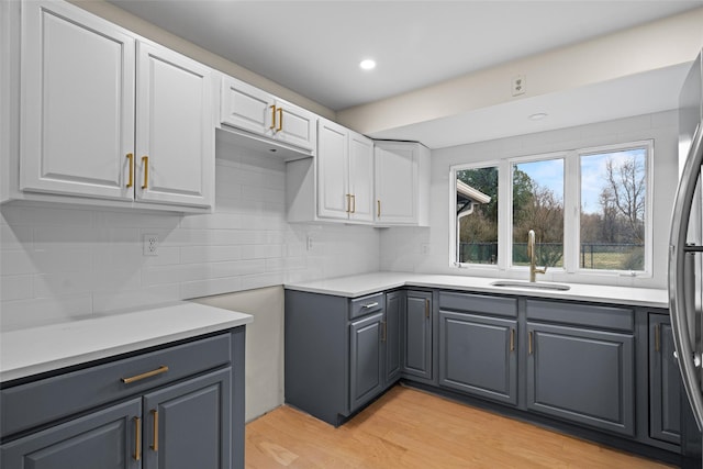 139 Cross Rd, Goshen, NY 10924 - kitchen with gray cabinets, decorative backsplash, a sink, and white cabinets