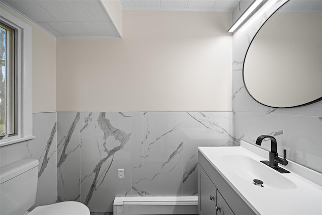 139 Cross Rd, Goshen, NY 10924 - bathroom with toilet, tile walls, vanity, and a wainscoted wall