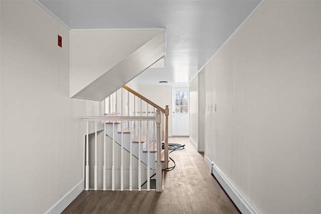 139 Cross Rd, Goshen, NY 10924 - hallway with baseboard heating, wood finished floors, baseboards, and stairs