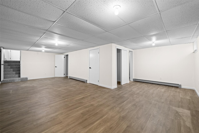 139 Cross Rd, Goshen, NY 10924 - finished basement featuring a drop ceiling, stairs, wood finished floors, and baseboard heating