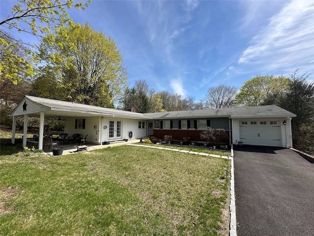 ranch-style home featuring aphalt driveway, a garage, a front yard, and french doors