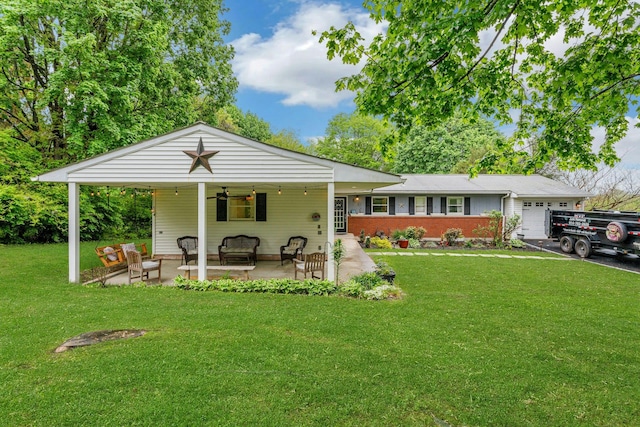 25 Macgregor Dr, Mahopac, NY 10541 - back of property featuring an attached garage, an outdoor hangout area, a ceiling fan, a yard, and a patio area