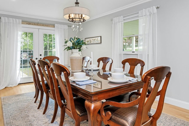 25 Macgregor Dr, Mahopac, NY 10541 - dining room with french doors, light wood-style flooring, ornamental molding, a chandelier, and baseboards
