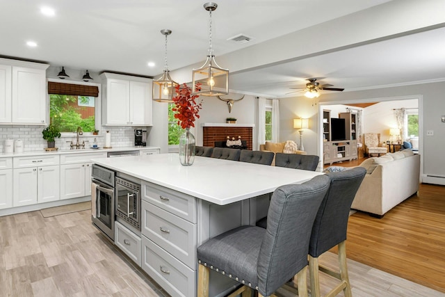 25 Macgregor Dr, Mahopac, NY 10541 - kitchen featuring a kitchen bar, open floor plan, decorative backsplash, healthy amount of natural light, and recessed lighting