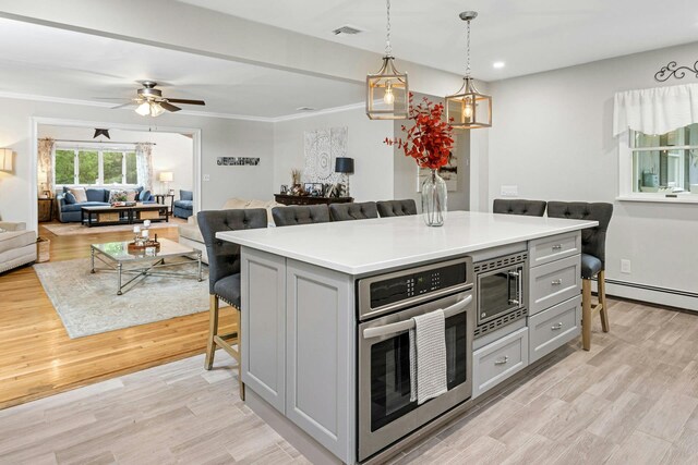 25 Macgregor Dr, Mahopac, NY 10541 - kitchen with appliances with stainless steel finishes, gray cabinets, open floor plan, light countertops, and a breakfast bar area