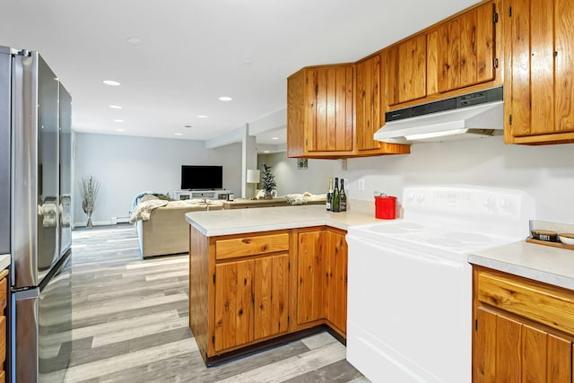 25 Macgregor Dr, Mahopac, NY 10541 - kitchen with under cabinet range hood, range with electric stovetop, freestanding refrigerator, light countertops, and recessed lighting