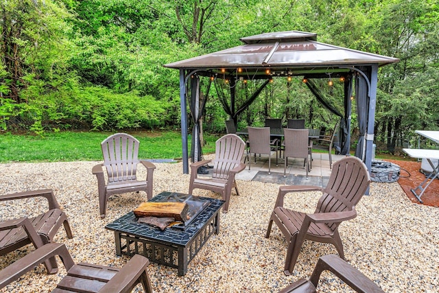 25 Macgregor Dr, Mahopac, NY 10541 - view of patio / terrace with a gazebo, outdoor dining area, a forest view, and a fire pit