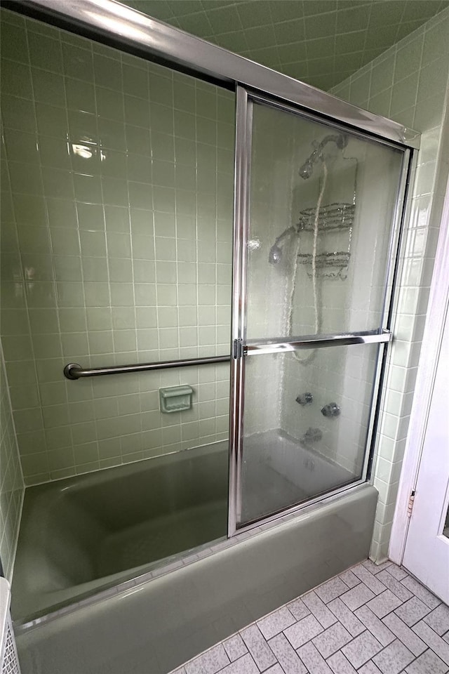 bathroom with shower / bath combination with glass door