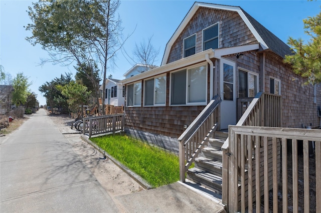 110 Ocean Rd, Ocean Beach, NY 11770 - view of front facade featuring a gambrel roof and roof with shingles