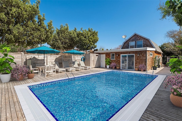 110 Ocean Rd, Ocean Beach, NY 11770 - view of swimming pool featuring a wooden deck and fence