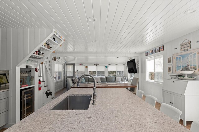 110 Ocean Rd, Ocean Beach, NY 11770 - kitchen with a sink, wine cooler, wooden ceiling, light stone countertops, and recessed lighting