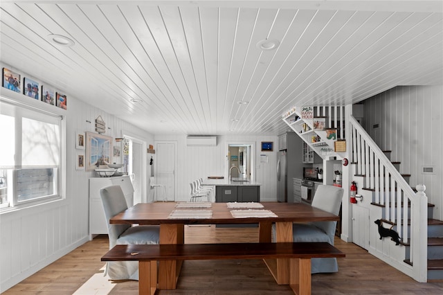 110 Ocean Rd, Ocean Beach, NY 11770 - dining space with stairs, an AC wall unit, light wood finished floors, wooden ceiling, and recessed lighting