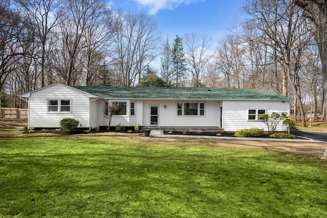 rear view of house with a lawn and entry steps
