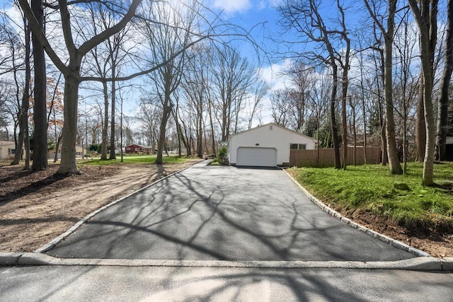 exterior space with fence and aphalt driveway