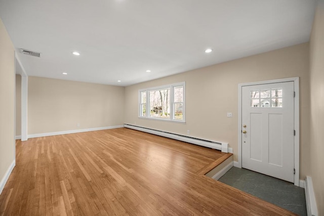 entrance foyer featuring visible vents, a baseboard radiator, light wood-style floors, and baseboards