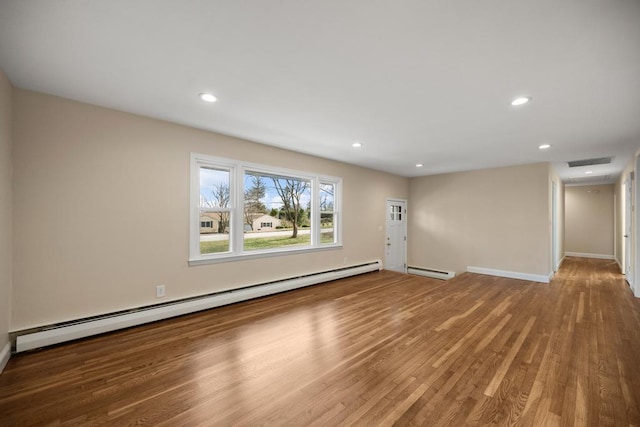 unfurnished living room with recessed lighting, baseboards, wood finished floors, and a baseboard radiator
