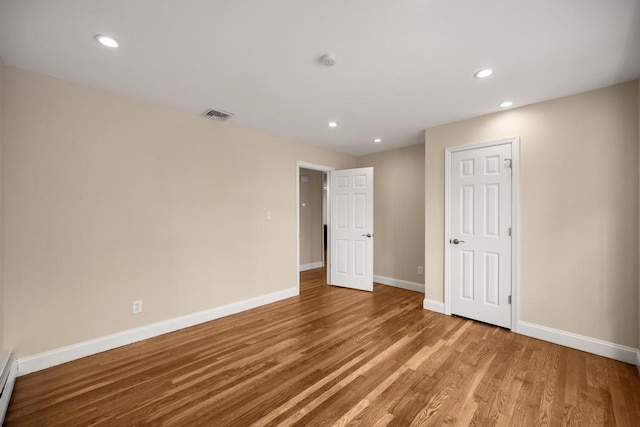 unfurnished bedroom with recessed lighting, baseboards, visible vents, and wood finished floors